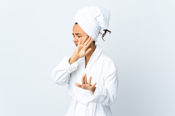 Young woman in bathrobe over isolated white background nervous stretching hands to the front