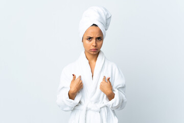 Young woman in bathrobe over isolated white background pointing to oneself