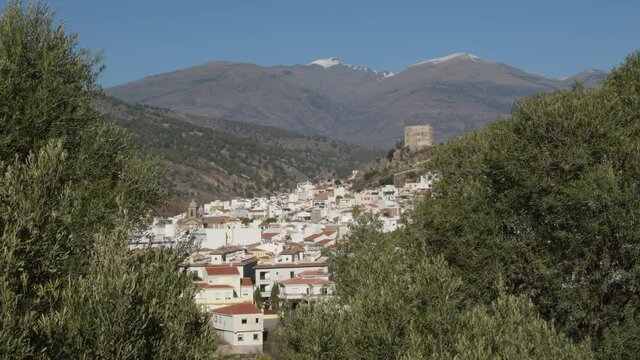 Velez de Benaudalla with Sierra Nevada at background a sunny day
