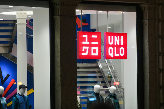 Uniqlo logo displayed on a facade of a store in Milan.