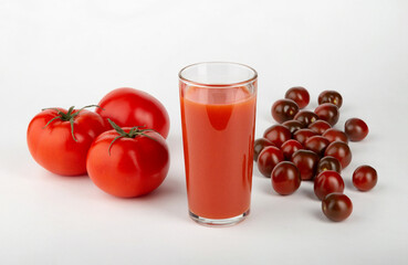 Tomato juice and fresh tomatoes on a white background.	