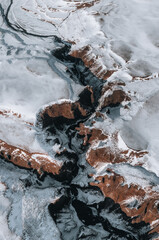 Aerial Drone view of Fjadrargljufur canyon and Fjadra river at winter. White snow and blue river. Iceland near Reykjavik.