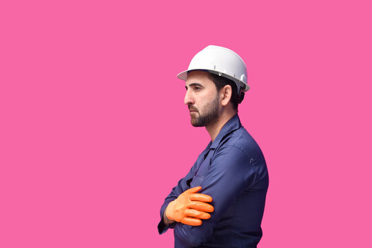 young construction worker standing with side pose folded arms indian pakistani model