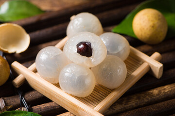 fresh peeled longans on wooden background