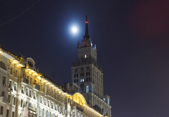 Obraz premium Moscow, Russia. Night view of skyscraper building at Krasnye Vorota square. Moon