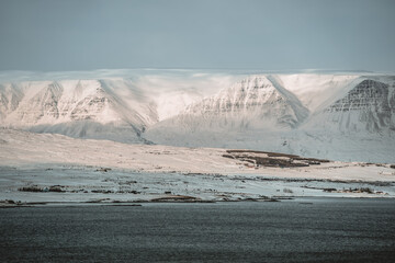 Panoramic view on Akureyri city in Iceland during winter with snow in the fjords and mountains.