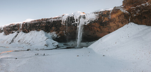 The beautiful Seljalandsfoss in Iceland during winter covered with snow.