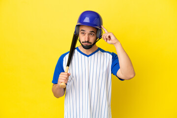 Young caucasian man playing baseball isolated on yellow background having doubts and thinking
