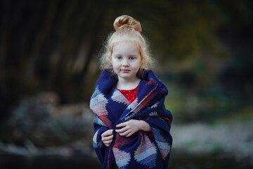 charming redheaded girl enjoying autumn in the park