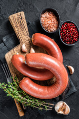 Sucuk meat sausage, Sujuk dry spicy sausage. Black background. Top view