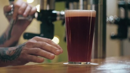 Barman pouring lambic into glass close-up, foamy cherry beer. Bartender pours cider, alcohol fruit red drink. Fresh beverage on bar counter background in pub.  - Powered by Adobe