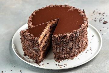 Chocolate cake with a cut piece, Layered chocolate cake tart