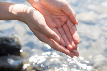 woman washing her hands in the river water
