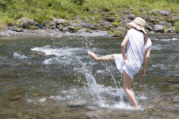 A girl playing with water in the river