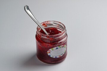 A screw jar of homemade strawberry jam. Isolated on white background.