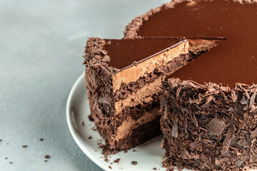 slice of tasty homemade chocolate cake on plate. Layered chocolate cake tart. banner, menu, recipe place for text, top view