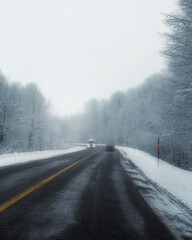 Obraz na płótnie Canvas Snowy and frozen mountain road in winter landscape