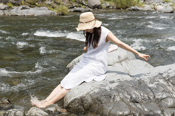 Girl on a rock in the river