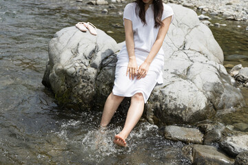 Girl on a rock in the river
