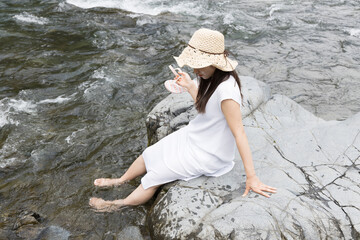 Girl on a rock in the river
