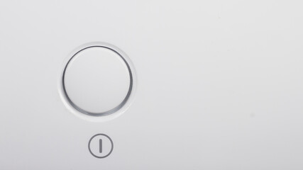 The start button, the on and off button of the device on the white surface