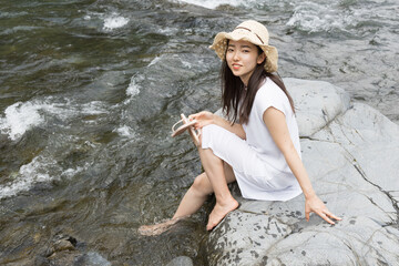 Girl on a rock in the river