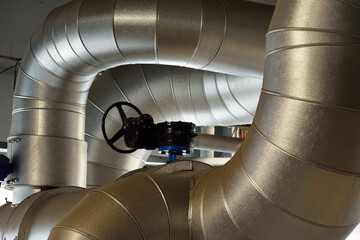Large industrial boiler room, new shiny pipes close-up. Central heating station. Industry,...