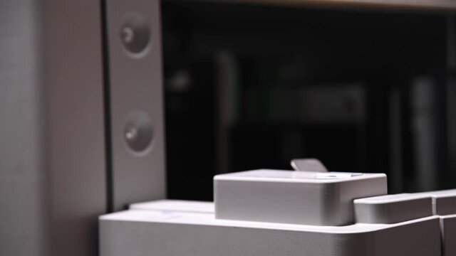 The man opens the cover of the printer to print on paper and cardboard to load paper. Close-up