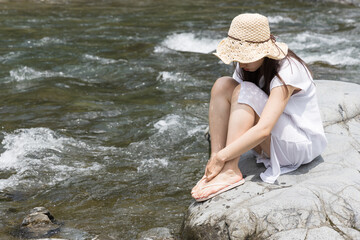 Girl on a rock in the river