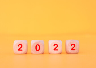 Wooden cube with 2022 text, concept to success of growing business.