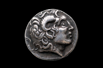 Greek silver Drachum coin replica of  Alexander the Great dated from 336-323 BC cut out and isolated on a black background, stock photo image © Tony Baggett