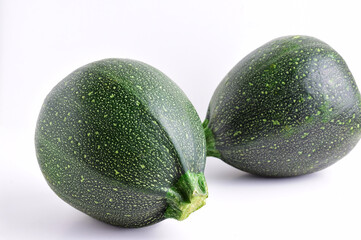Front shot, round zucchini on light background.