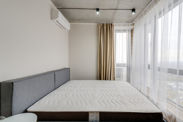 Bedroom in modern style with furniture and empty bed