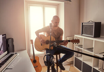 Fototapeta na wymiar guitar player recording at home studio