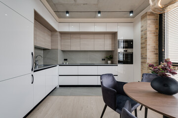 kitchen and dining table near the window in a modern interior in loft style