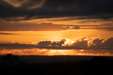 Sunset over a silhouetted landscape.