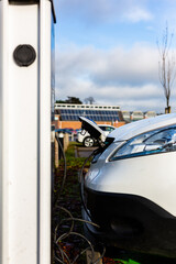 Electric car charging at plug in charge station in a public car park in Suffolk, UK