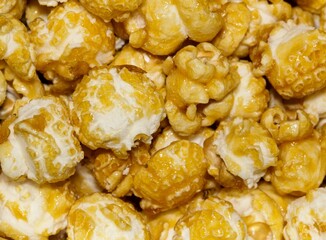 Caramel popcorn kernels up close with details and textures from directly above, selective focus.