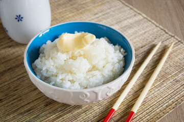 Japanese Uruchimai rice with a knob of butter in a pretty ceramic bowl