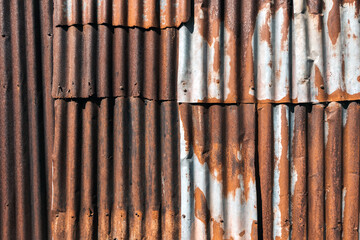 Old and rusty zinc sheet wall. Vintage style metal sheet roof texture. Pattern of old metal sheet. Rusting metal or siding. Corrosion of galvanized. Background and textures in retro concept.