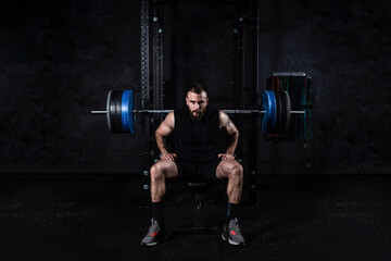 Young active strong sweaty muscular fit man with big muscles preparing for hardcore benchpress...