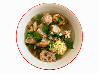 A bowl of meat ball soup with fresh vegetables, isolated on white background