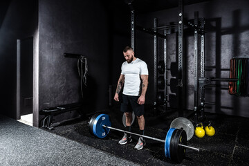 Young strong active athlete muscular fit man with big muscles preparing and concentration for...