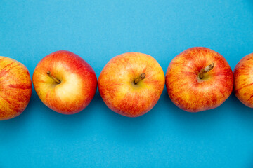 Top view of apples on blue background.