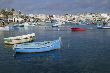 Fototapeta na wymiar Fishing boats and nets in Marsaxlokk 