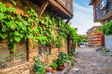 Fototapeta na wymiar City landscape - view of the old streets and homes in balkan style, the Old Town of Nessebar, on the Black Sea coast of Bulgaria