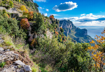 View along the Amalfi Coast of Italy from the Sentiero degli Dei, aka Path of the Gods, during December with autumn leaf color, white limestone cliffs and the turquoise blue Tyrrhenian Sea