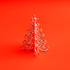 Silver metal Christmas tree on red background
