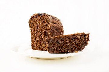 Sliced ​​black rye bread with raisins and seeds on a white plate. bread and baked goods
