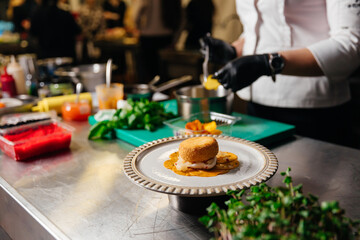 The chef is making a dessert for visitors.